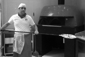 Raffaele - baking pizza in Rosso Vivo's wood-fired oven